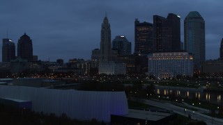 5.7K aerial stock footage reverse view of the river and the city skyline at twilight in Downtown Columbus, Ohio Aerial Stock Footage | DX0001_002768