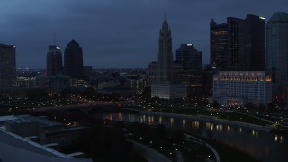 5.7K aerial stock footage of a reverse view of LeVeque Tower across the river at twilight, Downtown Columbus, Ohio Aerial Stock Footage | DX0001_002773