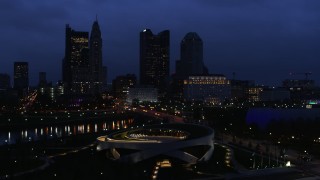 5.7K aerial stock footage of the city skyline across the bridge and river at twilight during descent, Downtown Columbus, Ohio Aerial Stock Footage | DX0001_002776