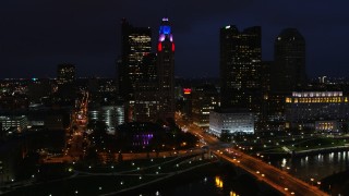 DX0001_002794 - 5.7K aerial stock footage fly away from city skyline at night, reveal river, bridge and concert hall, Downtown Columbus, Ohio