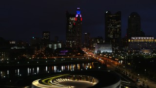 DX0001_002795 - 5.7K aerial stock footage fly over concert hall by bridge and river to approach skyline at night, Downtown Columbus, Ohio