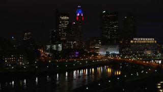 DX0001_002804 - 5.7K aerial stock footage of LeVeque Tower and bridge spanning the river at night seen during descent, Downtown Columbus, Ohio