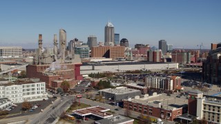 DX0001_002805 - 5.7K aerial stock footage of the city skyline seen while flying by brick factory, Downtown Indianapolis, Indiana