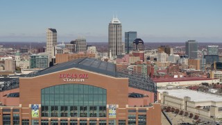 5.7K aerial stock footage of flying by the football stadium, with the skyline in the background in Downtown Indianapolis, Indiana Aerial Stock Footage | DX0001_002825