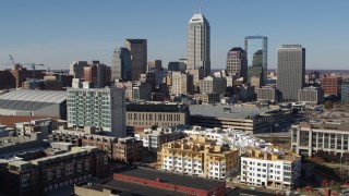 5.7K aerial stock footage of focusing on the city's skyline while flying near arena in Downtown Indianapolis, Indiana Aerial Stock Footage | DX0001_002844