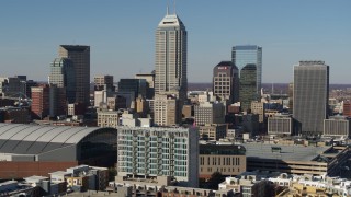 5.7K aerial stock footage of slowly flying by tall skyscrapers in the city's skyline, reveal arena in Downtown Indianapolis, Indiana Aerial Stock Footage | DX0001_002860