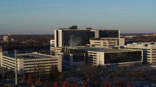 5.7K aerial stock footage of flying by a hospital complex at sunset in Indianapolis, Indiana Aerial Stock Footage | DX0001_002915