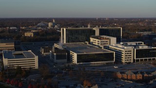 5.7K aerial stock footage of flying by a large hospital complex at sunset in Indianapolis, Indiana Aerial Stock Footage | DX0001_002916