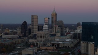 5.7K aerial stock footage of a reverse view of the city's skyline at sunset in Downtown Indianapolis, Indiana Aerial Stock Footage | DX0001_002947