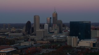 5.7K aerial stock footage flying by the city's skyline and a hotel at sunset in Downtown Indianapolis, Indiana Aerial Stock Footage | DX0001_002948