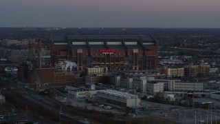 5.7K aerial stock footage slowly flying away from a football stadium at sunset, Downtown Indianapolis, Indiana Aerial Stock Footage | DX0001_002953