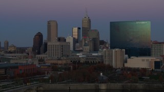 DX0001_002958 - 5.7K aerial stock footage of slowly flying by hotel and city skyline at twilight in Downtown Indianapolis, Indiana