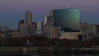 5.7K aerial stock footage of slowly descending by hotel and city skyline at twilight in Downtown Indianapolis, Indiana Aerial Stock Footage | DX0001_002959