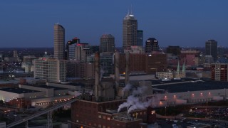 5.7K aerial stock footage fly past smoke stacks at twilight with skyline in background, Downtown Indianapolis, Indiana Aerial Stock Footage | DX0001_002962