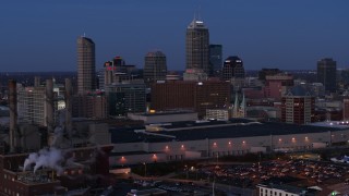 5.7K aerial stock footage slowly pass smoke stacks at twilight with skyline in background, Downtown Indianapolis, Indiana Aerial Stock Footage | DX0001_002963