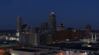 DX0001_002974 - 5.7K aerial stock footage flyby giant skyscrapers of the city skyline at twilight, reveal smoke stacks, Downtown Indianapolis, Indiana