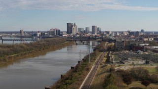 DX0001_002996 - 5.7K aerial stock footage ascend over river with view of the city's skyline in Downtown Louisville, Kentucky