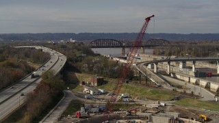 DX0001_003017 - 5.7K aerial stock footage construction crane near railroad bridge and locks and a dam on the Ohio River in Louisville, Kentucky