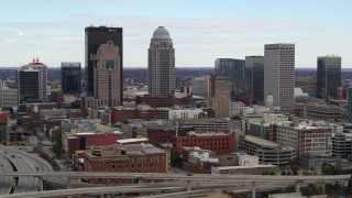 DX0001_003018 - 5.7K aerial stock footage descend near freeway offramp with view of city skyline in Downtown Louisville, Kentucky