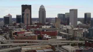 DX0001_003020 - 5.7K aerial stock footage of city skyline seen while flying by freeway offramp in Downtown Louisville, Kentucky