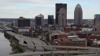 5.7K aerial stock footage ascend over freeway with view of skyscrapers in Downtown Louisville, Kentucky Aerial Stock Footage | DX0001_003024