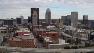 5.7K aerial stock footage slow pass by the city's skyline beside a freeway in Downtown Louisville, Kentucky Aerial Stock Footage | DX0001_003030