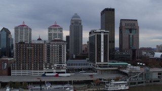 DX0001_003051 - 5.7K aerial stock footage fly over Ohio River to approach riverfront hotel and skyscrapers in Downtown Louisville, Kentucky