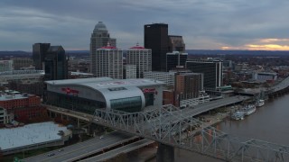 5.7K aerial stock footage flyby bridge and ascend near arena and skyline at sunset, Downtown Louisville, Kentucky Aerial Stock Footage | DX0001_003068