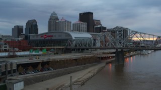 5.7K aerial stock footage flyby freeway near the arena and city skyline, and bridge spanning river at sunset, Downtown Louisville, Kentucky Aerial Stock Footage | DX0001_003073