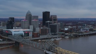 DX0001_003081 - 5.7K aerial stock footage reverse view of city skyline at sunset while ascending by the bridge, Downtown Louisville, Kentucky