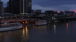 5.7K aerial stock footage orbit small riverboat at twilight in Downtown Louisville, Kentucky Aerial Stock Footage | DX0001_003093