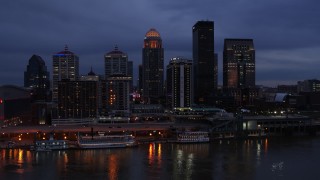 DX0001_003096 - 5.7K aerial stock footage reverse view of the skyline at twilight, seen from Ohio River, Downtown Louisville, Kentucky