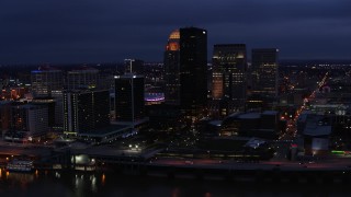 5.7K aerial stock footage reverse view of the city's skyline at twilight, reveal Ohio River, Downtown Louisville, Kentucky Aerial Stock Footage | DX0001_003108