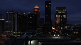 DX0001_003114 - 5.7K aerial stock footage of flying by a hotel and skyscrapers at twilight, Downtown Louisville, Kentucky