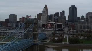 5.7K aerial stock footage descend by bridge to reveal river while focused on the city skyline, Downtown Cincinnati, Ohio Aerial Stock Footage | DX0001_003138