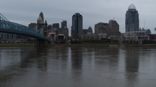 5.7K aerial stock footage descend toward the river by bridge while focused on city skyline, Downtown Cincinnati, Ohio Aerial Stock Footage | DX0001_003150