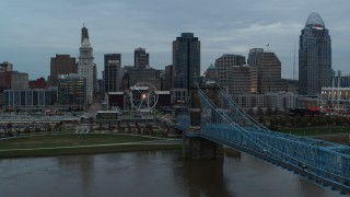 5.7K aerial stock footage follow bridge over the river toward the city skyline at sunset, Downtown Cincinnati, Ohio Aerial Stock Footage | DX0001_003151