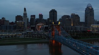 5.7K aerial stock footage flyby city skyline and Ferris wheel at sunset, reveal bridge and Ohio River, Downtown Cincinnati, Ohio Aerial Stock Footage | DX0001_003161