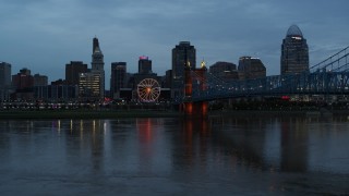 5.7K aerial stock footage descend by Ohio River at sunset with view of bridge and skyline, Downtown Cincinnati, Ohio Aerial Stock Footage | DX0001_003162