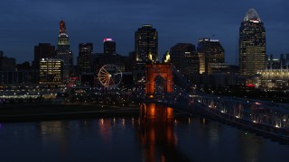 5.7K aerial stock footage ascend from river by bridge to approach city skyline at twilight, Downtown Cincinnati, Ohio Aerial Stock Footage | DX0001_003181