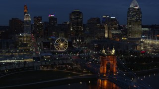 5.7K aerial stock footage fly over Ohio River to approach Ferris wheel and skyline at twilight, Downtown Cincinnati, Ohio Aerial Stock Footage | DX0001_003184