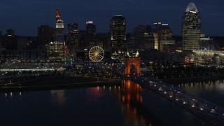 5.7K aerial stock footage descend by the bridge with a view of the skyline across the river at twilight, Downtown Cincinnati, Ohio Aerial Stock Footage | DX0001_003188