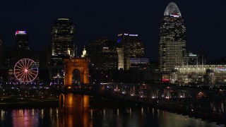 5.7K aerial stock footage fly over Roebling Bridge at night to approach city skyline, Downtown Cincinnati, Ohio Aerial Stock Footage | DX0001_003191