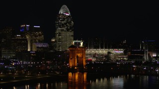 DX0001_003199 - 5.7K aerial stock footage orbit Roebling Bridge at night with city skyline in background, Downtown Cincinnati, Ohio