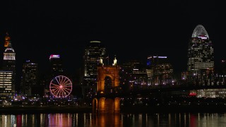 DX0001_003202 - 5.7K aerial stock footage of the Roebling Bridge at night with city skyline in background, Downtown Cincinnati, Ohio