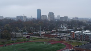 5.7K aerial stock footage ascend from football field for view of the city skyline, Downtown Lexington, Kentucky Aerial Stock Footage | DX0001_003203