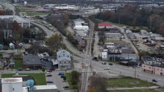 5.7K aerial stock footage reverse view of a busy street and railroad tracks in industrial area in Lexington, Kentucky Aerial Stock Footage | DX0001_003224