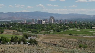 5.7K aerial stock footage of a view of the distant city skyline from a park in Reno, Nevada Aerial Stock Footage | DX0001_004_006