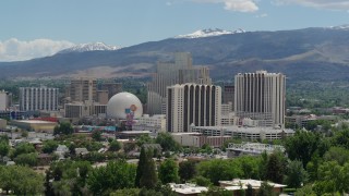 5.7K aerial stock footage of hotels and casinos with mountains in the distance in Reno, Nevada Aerial Stock Footage | DX0001_004_009