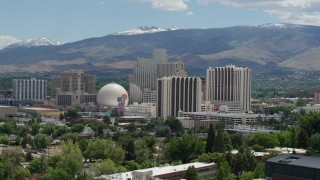 DX0001_004_011 - 5.7K aerial stock footage of resort hotels and casinos with mountains in the distance in Reno, Nevada